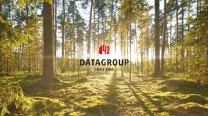 Het DATAGROUP-logo met een “40” en de tekst “Since 1983” verschijnt tegen de achtergrond van een helder verlicht bos bij zonsondergang.